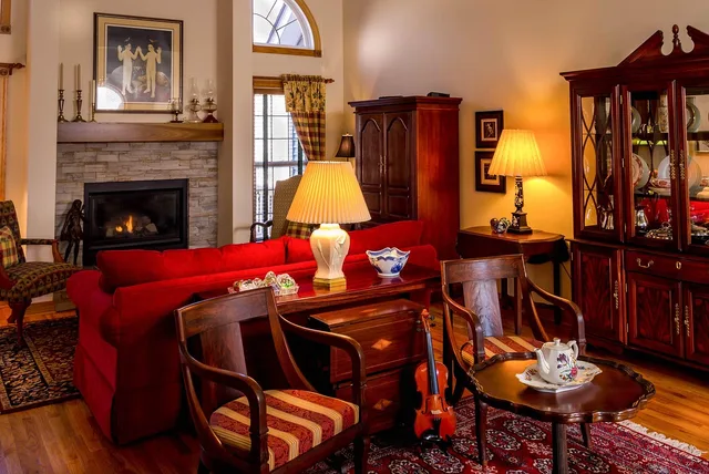 living room, family room, great room, antique furniture, interior design, staging, fireplace, chairs, sofa, tea table, rug, hardwood floor, china cabinet, seating arrangement, lamps, brown tea, brown room, brown table, brown design, brown interior, brown lamp, living room, living room, antique furniture, fireplace, fireplace, fireplace, fireplace, fireplace. Which period interior upgrades you notice every day, and which you stop noticing